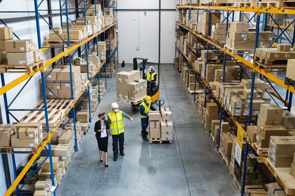 Top view of a group of workers with manager working indoors in warehouse, coronavirus concept.